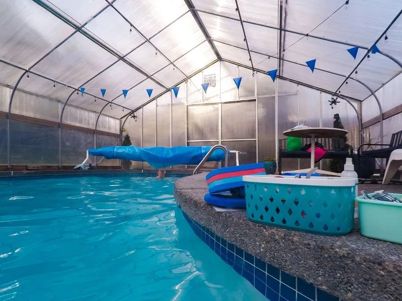 West pool - greenhouse-covered heated pool